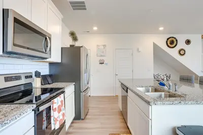 a kitchen with white cabinets and a sink at Near Hiking, Golfing and Fishing Colorado Retreat! in Henderson