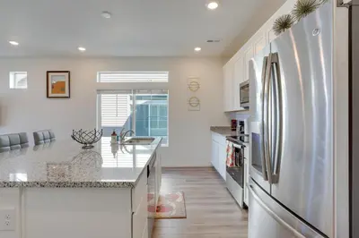 a kitchen with a refrigerator and a counter top at Near Hiking, Golfing and Fishing Colorado Retreat! in Henderson