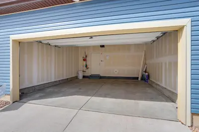 an empty garage with an open garage door at Near Hiking, Golfing and Fishing Colorado Retreat! in Henderson
