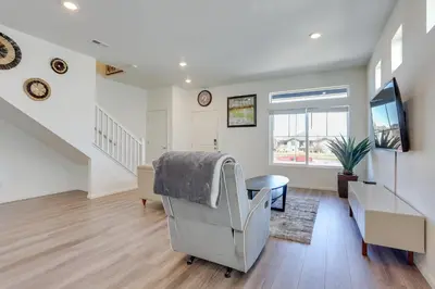 a living room with a chair and a tv at Near Hiking, Golfing and Fishing Colorado Retreat! in Henderson