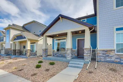 a house with a front porch and a driveway at Near Hiking, Golfing and Fishing Colorado Retreat! in Henderson
