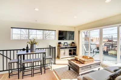 a living room with a table and chairs at Modern Erie Home - Walk to Downtown! in Erie