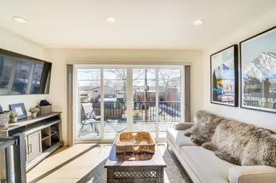 a living room with a couch and a table at Modern Erie Home - Walk to Downtown! in Erie