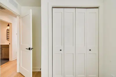a white closet with white doors in a room at Modern Erie Home - Walk to Downtown! in Erie
