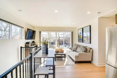 a living room with a couch and a table at Modern Erie Home - Walk to Downtown! in Erie
