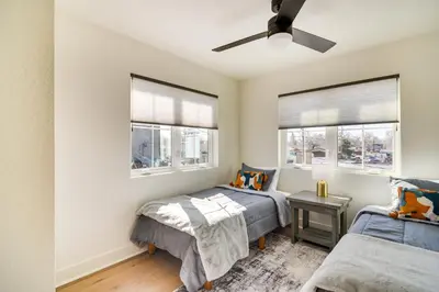 a bedroom with two beds and two windows at Modern Erie Home - Walk to Downtown! in Erie