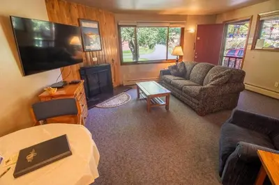 a living room with a couch and a table at Castle Mountain Lodge in Estes Park