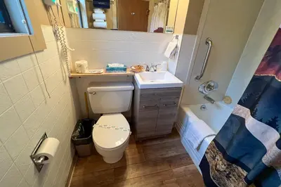 a small bathroom with a toilet and a sink at Castle Mountain Lodge in Estes Park