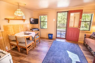 a living room with a table and a couch at Castle Mountain Lodge in Estes Park