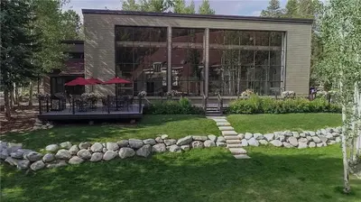 a house with a stone path in front of a yard at 2056 The Pines condo in Keystone