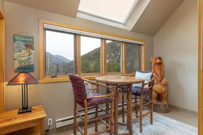 a dining room with a table and chairs and a window at 2056 The Pines condo in Keystone