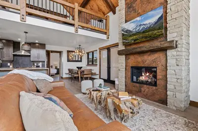 a living room with a couch and a fireplace at Luxury Cabin! Fireplace and Jacuzzi! in Estes Park