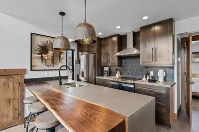 a kitchen with wooden cabinets and a wooden counter top at Luxury Cabin! Fireplace and Jacuzzi! in Estes Park