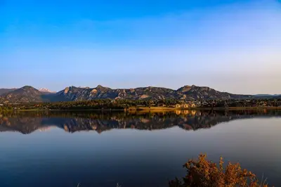 a view of a lake with mountains in the background at Luxury Cabin! Fireplace and Jacuzzi! in Estes Park