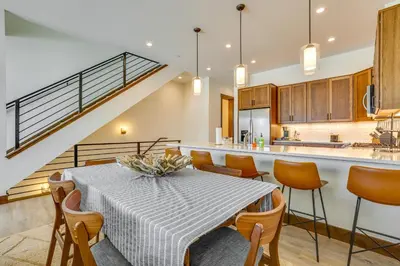 a kitchen and dining room with a table and chairs at Modern Fraser Townhome with Private Hot Tub and Decks! in Fraser