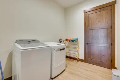 a washer and dryer in a room with a door at Modern Fraser Townhome with Private Hot Tub and Decks! in Fraser