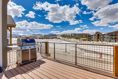 a grill on a deck with a view of the water at Modern Fraser Townhome with Private Hot Tub and Decks! in Fraser
