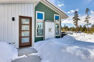 a house with a door in the snow at Fraser Vacation Rental - Shuttle to Winter Park! in Fraser