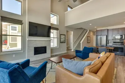 a living room with blue furniture and a fireplace at Fraser Vacation Rental - Shuttle to Winter Park! in Fraser