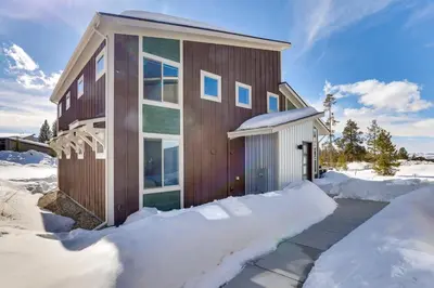a house in the snow with a driveway at Fraser Vacation Rental - Shuttle to Winter Park! in Fraser