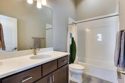 a bathroom with a sink and a toilet and a tub at Fraser Vacation Rental - Shuttle to Winter Park! in Fraser
