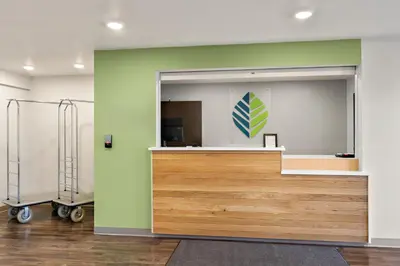 a room with a counter with a large mirror at WoodSpring Suites Fort Collins in Fort Collins
