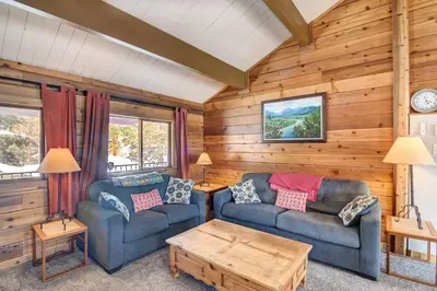a living room with two couches and a coffee table at Hot Tub and Mtn Views Waterfront Grand Lake Cabin! in Grand Lake