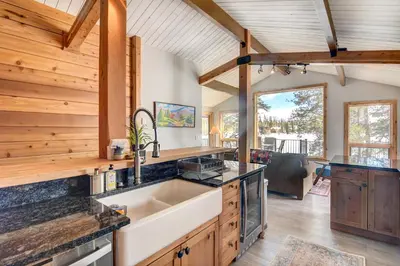 a kitchen with wooden walls and a ceiling at Hot Tub and Mtn Views Waterfront Grand Lake Cabin! in Grand Lake