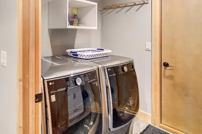 a washer and dryer sitting inside of a room at Hot Tub and Mtn Views Waterfront Grand Lake Cabin! in Grand Lake