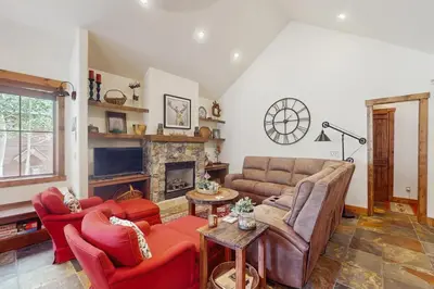 a living room with a couch and a fireplace at Cozy Cabin Retreat in Grand Lake