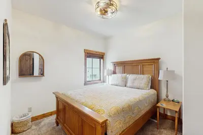 a bedroom with a bed and a window at Cozy Cabin Retreat in Grand Lake