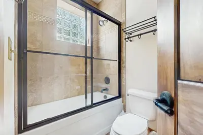 a bathroom with a shower and a toilet at Cozy Cabin Retreat in Grand Lake