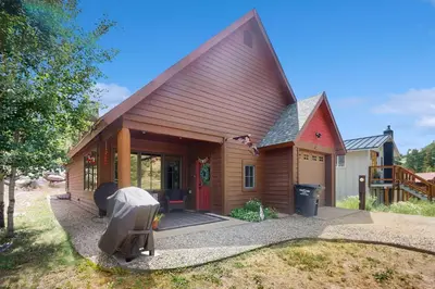 a small wooden house with a large roof at Cozy Cabin Retreat in Grand Lake