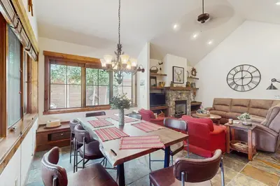 a living room with a table and chairs and a couch at Cozy Cabin Retreat in Grand Lake