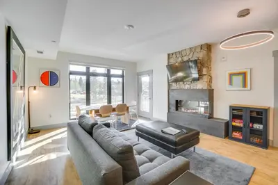 a living room with a couch and a fireplace at Modern Winter Park Condo with Community Hot Tub! in Winter Park