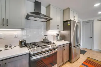 a kitchen with a stove and a refrigerator at Modern Winter Park Condo with Community Hot Tub! in Winter Park