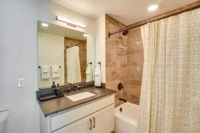 a bathroom with a sink and a shower and a tub at Modern Winter Park Condo with Community Hot Tub! in Winter Park