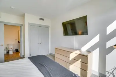 a bedroom with a bed and a tv on the wall at Modern Winter Park Condo with Community Hot Tub! in Winter Park