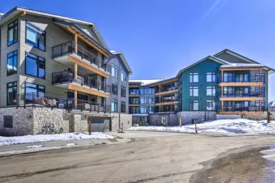 an apartment building with a parking lot in front of it at Modern Winter Park Condo with Community Hot Tub! in Winter Park