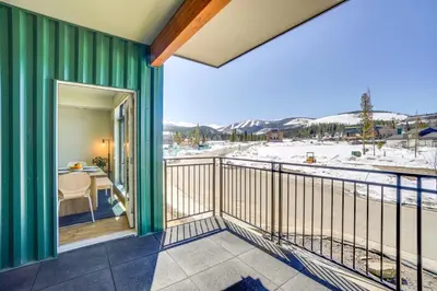 a balcony with a view of the snow covered mountains at Modern Winter Park Condo with Community Hot Tub! in Winter Park