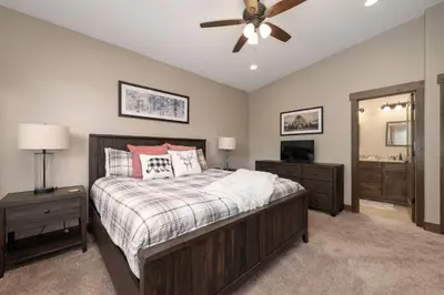 a bedroom with a bed and a ceiling fan at Mountain Haus home in Fraser