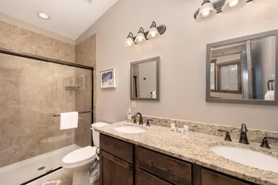 a bathroom with a sink and a toilet and a shower at Mountain Haus home in Fraser