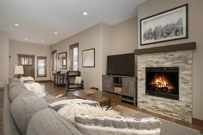 a living room with a couch and a fireplace at Mountain Haus home in Fraser