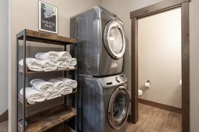 a laundry room with a washing machine and towels at Mountain Haus home in Fraser