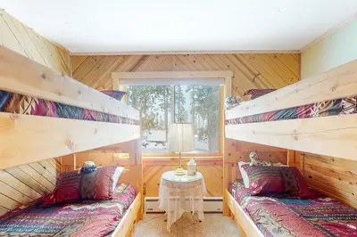 two bunk beds in a room with a window at Wapiti Point in Grand Lake