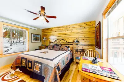 a bedroom with a bed and a ceiling fan at Wapiti Point in Grand Lake