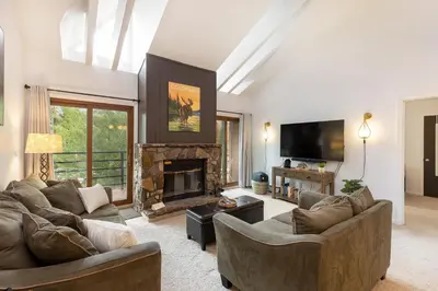 a living room with two couches and a fireplace at Mountain view, kids room, great location! in Silverthorne