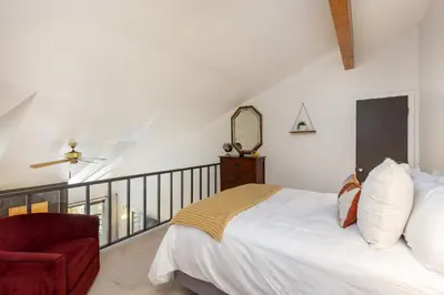 a bedroom with a white bed and a red chair at Mountain view, kids room, great location! in Silverthorne
