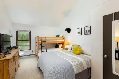a bedroom with a bunk bed and a television at Mountain view, kids room, great location! in Silverthorne