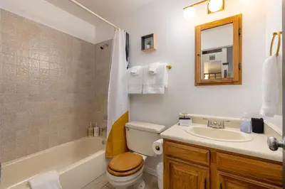 a bathroom with a sink and a toilet and a tub at Mountain view, kids room, great location! in Silverthorne
